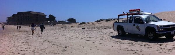 Lifeguard is cruising the beach in a very buffed out nice truck.