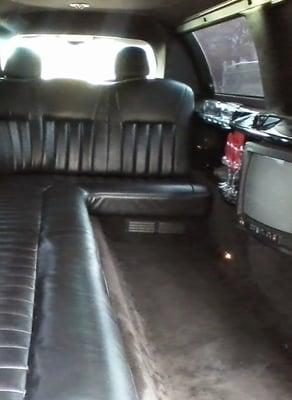 9 passenger Lincoln Town Car Limousine - has tv, cd/dvd player, am/fm stereo, neon lighting and bar.