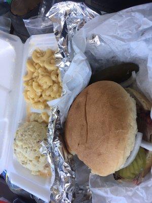 Brisket sandwich with potato salad and Mac and cheese