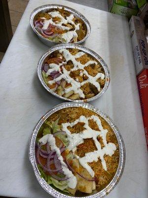 Delicious combo over rice ( chicken and lamb with lettuce' tomato , onion and white sauce and hot sauce)