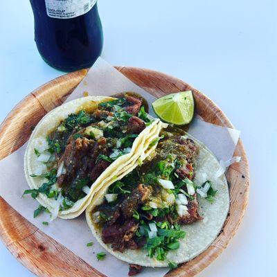 Tripa Tacos. Served with chopped onions and cilantro, and a tasty hot sauce.