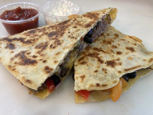 Beef Quesadilla with bell peppers, onions, black beans, cheddar cheese, salsa and sour cream.