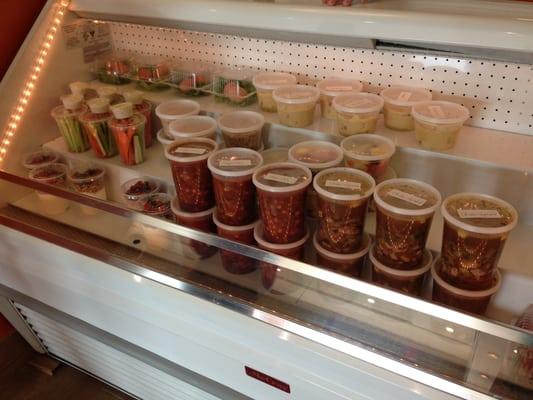 Grab and Go case - homemade soups to go, fruit cup, vegetable cup, brown eggs, greek yogurt, sandwiches