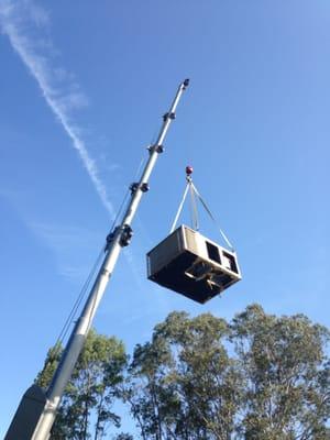 Removing the old unit from a roof.