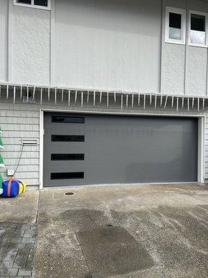 Cloplay modern steel insulated garage door gray color with thin style 38 inch wide dark tinted double pane glass with black thin bezels.