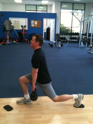 Achieve Health and Fitness Client Paul C. working the Valslide Reverse Lunge.