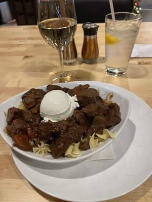 Beef Tips with carrots and gravy over pasta.