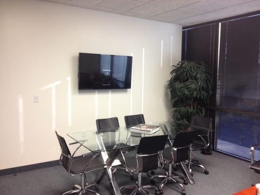 47" flat screen, hidden components, slim mount, in office boardroom.