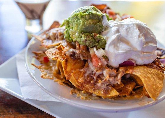 Personal BBQ nachos with sour cream and guac