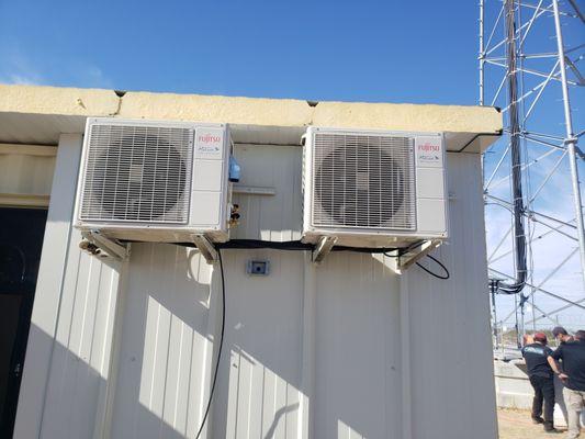 U.S. Marine Corp remote radio tower battery conex box. Installing 115 volt mini split heat pump condensers.