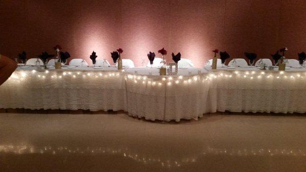 Head table. We call the sweetheart table with lights and lace.