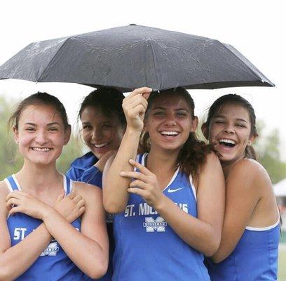 Horsemen trackletes smiling for a photo.