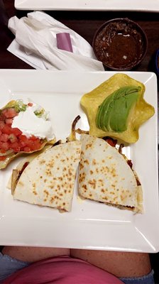 Chicken Fajita Quesadilla with a side of sliced avocado