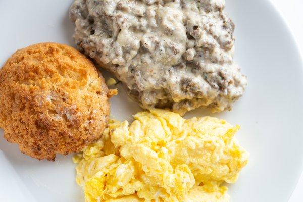 A fluffy almond flour biscuit paired with turkey pan sausage cream gravy made with heavy cream and bone broth and scrambled eggs