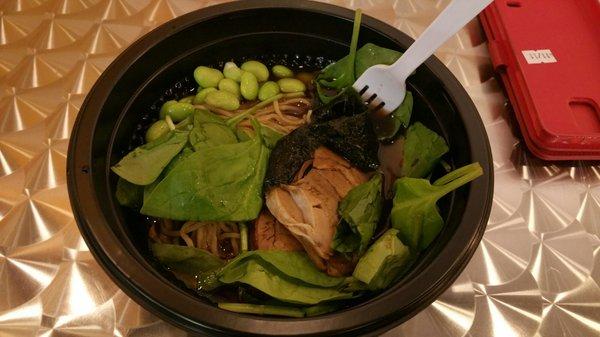 Ramen in shoyu broth with pork chashu, spinach, edamame, and seaweed