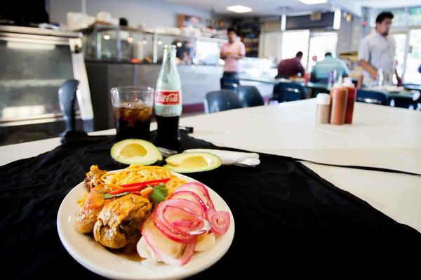 Chicken stewed, Yuca with onions, Spaghetti and avocado. With a traditional coke.