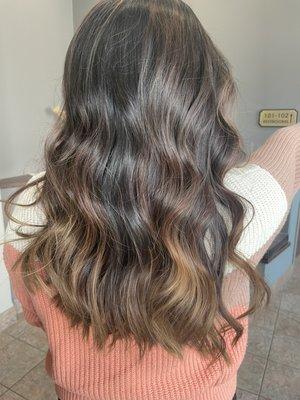 Soft balayage highlight with natural warm brunette tones.