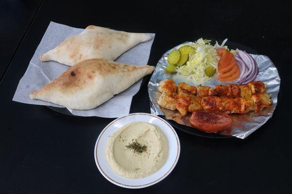 Chicken Kebab Platter served with bread and hummus.