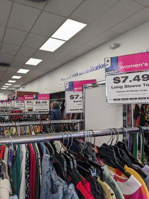 Racks of women's clothes with pricing