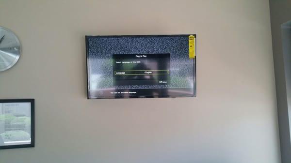 Flat screen TV mounted to wall.