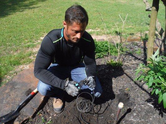 Repairing outdoor lighting low voltage wires.