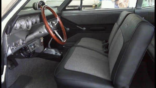 Front seat. Black vinyl over grey tweed. The dash pad was completely rebuilt an covered as well as the silver paint on the dash.