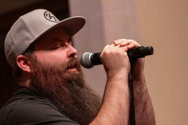 Nick (He/Him) sings Foo Fighters at the Spring 2024 recital. Photo by Queer Lenz Photography.