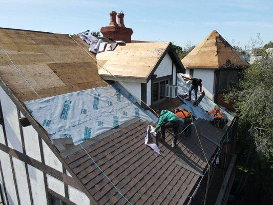 above and beyond crew installing new waterproof  and new shingles per city code