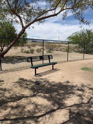 Inside the gated small dog area. There's a bench but no covered shelter.