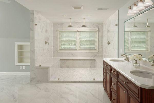 A roomy stand in shower with bench and a his and hers sink vanity. *Real FTC Interiors Re-design