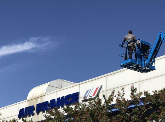 LAX airport, team on a lift finalizing a security system for Air France