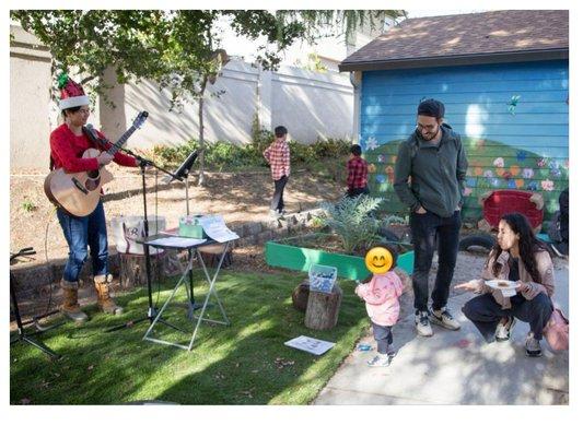 Rosemarie Austin performs with audience participation at preschool holiday festival.