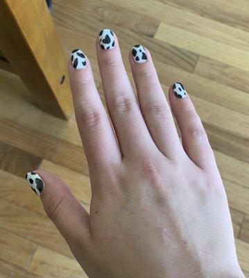 Cow themed nails.