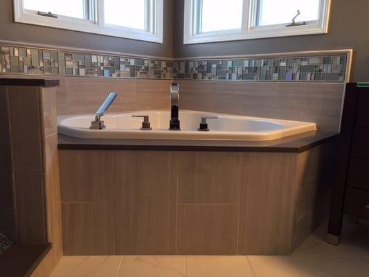 Bathroom remodel with corner soaker tub.