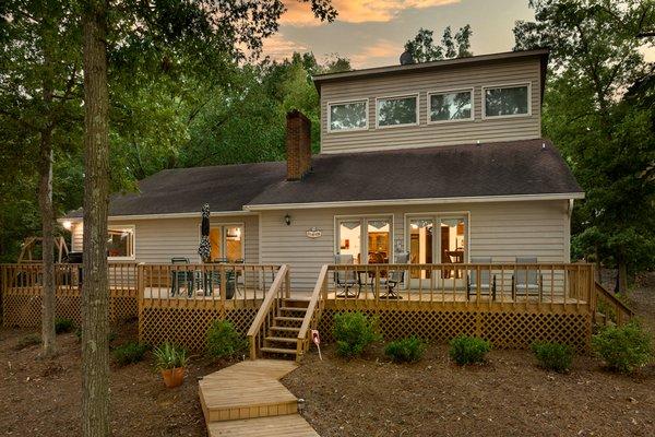 Here is a twilight shot of a beautiful house nestled in the woods. www.sixcentsmedia.com