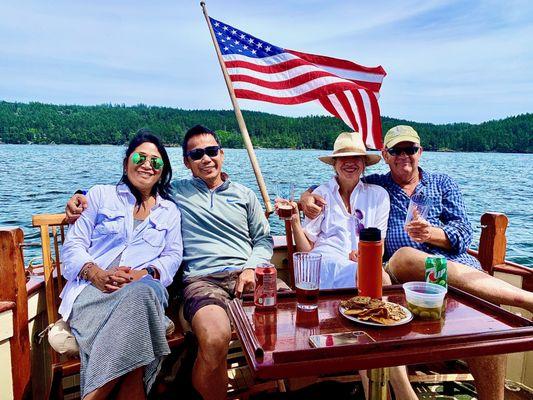 Guests enjoying a beautiful day on the water aboard Orcas Island Historic Yacht Tours