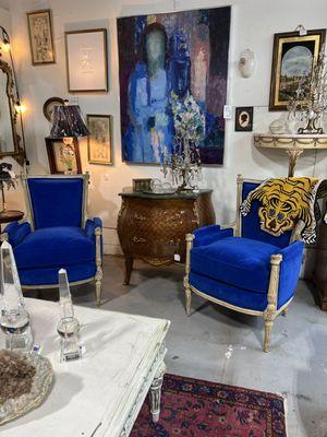 A pair of blue velvet chairs.
Original art work 
A beautiful commode with marble top!