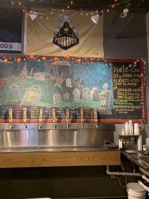 Cool decorated board and their fa beer selections, as well as prices