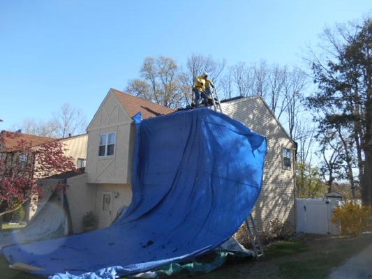 Recent roof job in Pennsauken NJ. Our crews protect home gardens and lawns while working. 