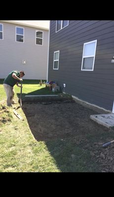 Before picture of a patio getting prepped