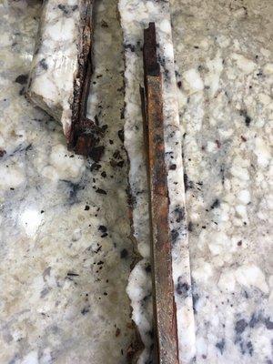 Rusted support rod that has caused the crack.