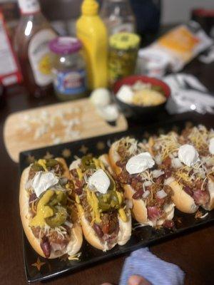 Fully loaded chili dogs with jalapeño peppers, cheese, bacon, and sour cream