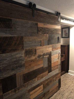 "patchwork" barn door used as a room divider.