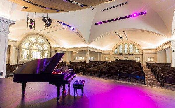 A piano on the stage of the Great Hall.