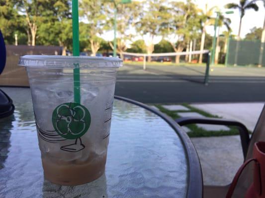 Enjoying a Starbucks at the club. This is one of my favorite places to play tennis in Miami.