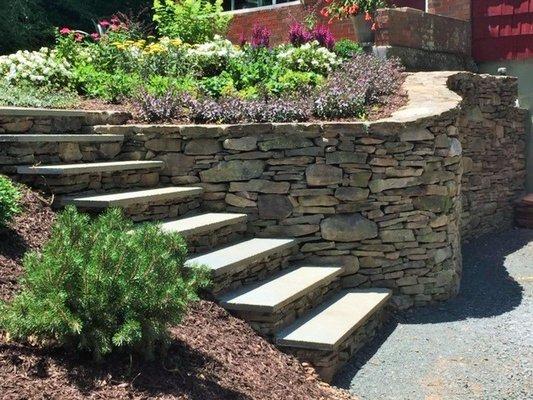 Natural stone wall with bluestone steps.