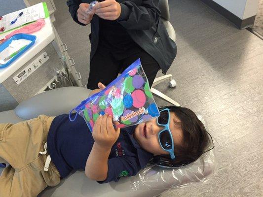 2yo's first cleaning experience, complete with a goodie bag, glasses for the bright light and movie playing overhead.