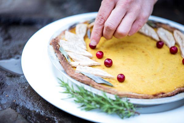 Wild-foraged cranberries adorn a gluten-free pumpkin pie.