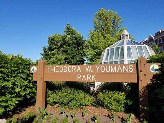 Small park hidden behind a large sign.