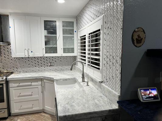 Dolomite, laminated countertops with new glass tile backsplash